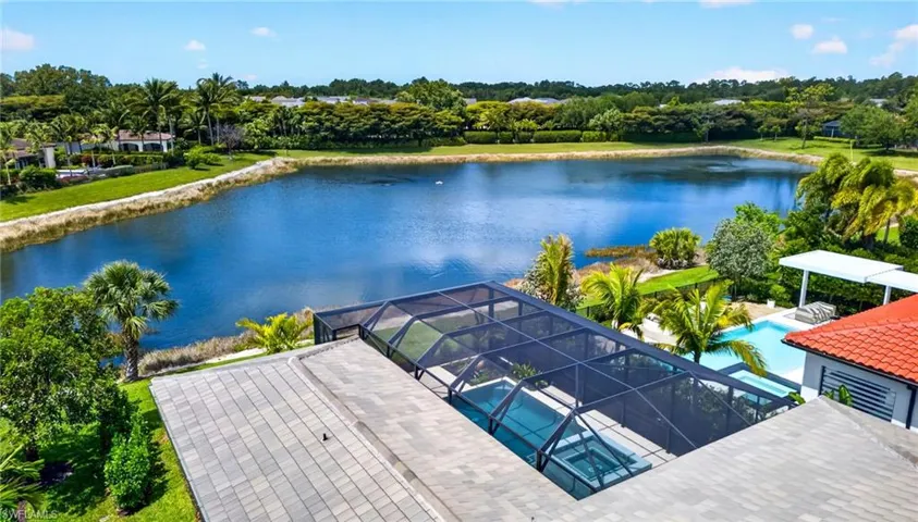 Bird's eye view of a nearby body of water and a tree filled landscape