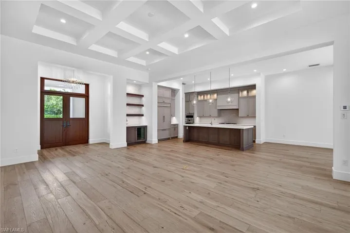 Beautiful 10 feet tall wood entry doors , open flow from living space and kitchen island and wet bar