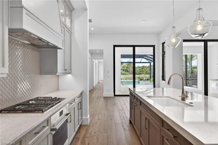 Sub zero Wolf appliances, beautiful countertops and stunning tile backsplash