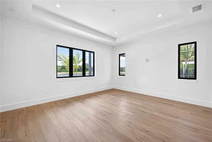 Master bedroom, features wood floors and many windows allowing for natural lighting