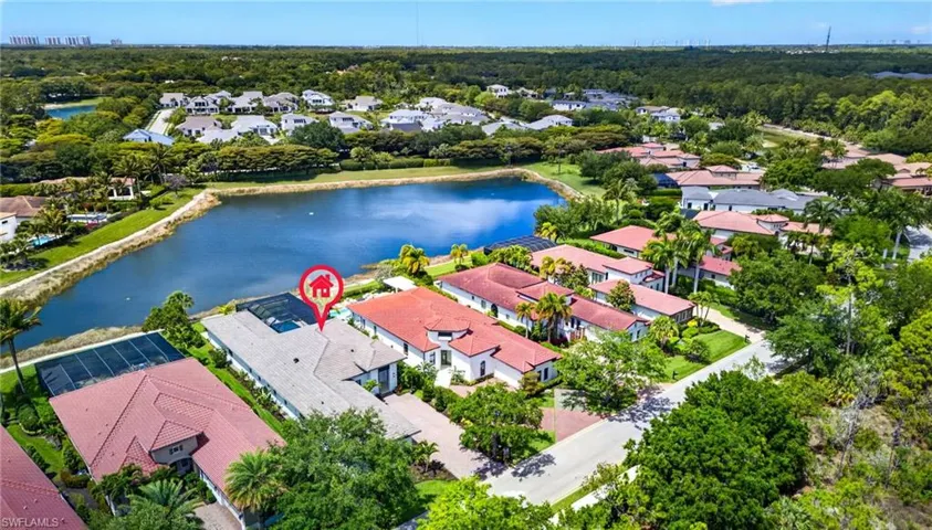 Aerial view of residential area featuring a nearby body of water