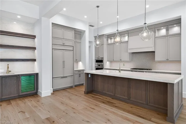 Stylish wine/wet bar accents the large kitchen island