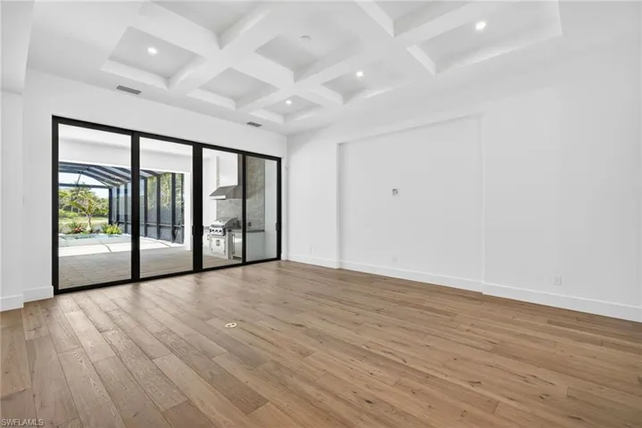 Tray ceiling and recessed lighting ,natural  light flows through the large sliding glass doors