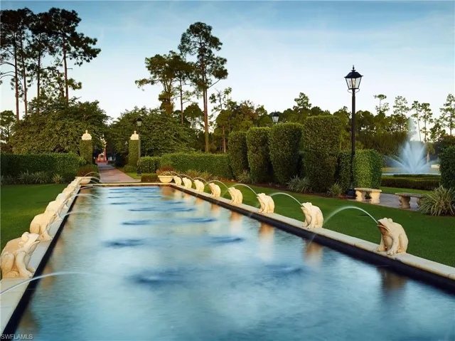 The property features an extensive decorative pond with multiple frog-shaped water spouts
