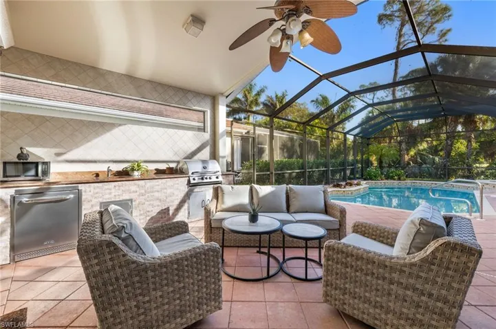 Fabulous Indoor/Outdoor Living! Outdoor Kitchen + convenient Electric Hurricane Shutters for covered lanai.