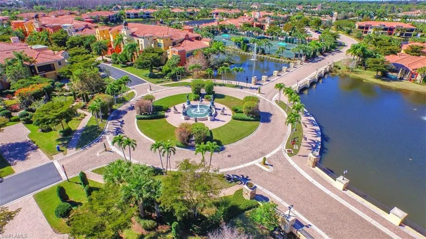 Aerial view of property's location featuring a nearby body of water and nearby suburban area