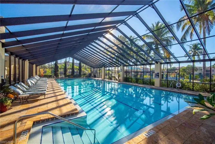 Indoor community pool with a lanai and a patio area