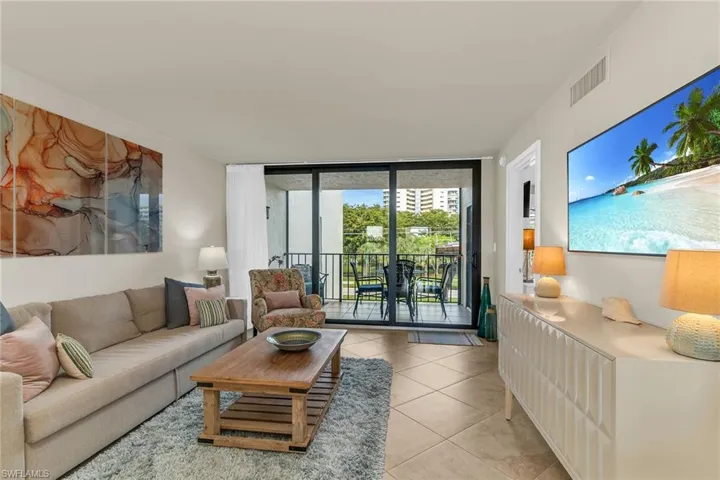 Living area with light tile patterned floors and expansive windows
