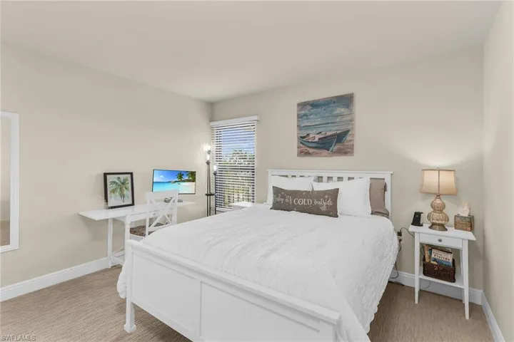Bedroom with baseboards and carpet