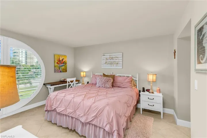 Bedroom featuring light tile patterned flooring and baseboards