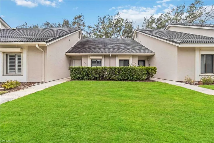 Back of property featuring a yard