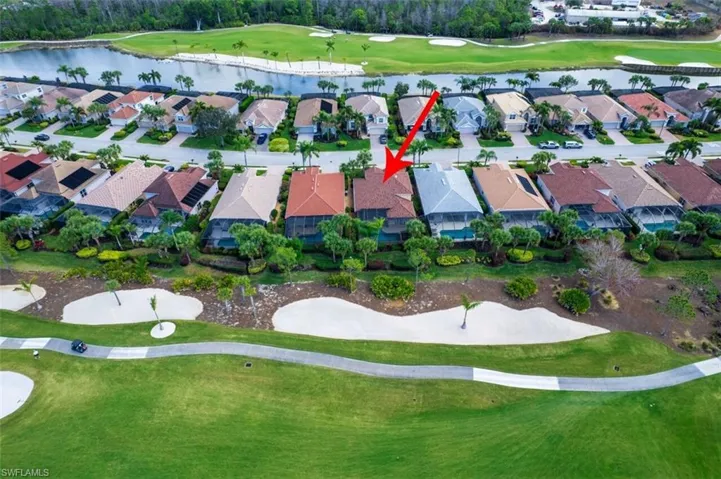 Aerial overview of property's location with a local golf course and a large body of water