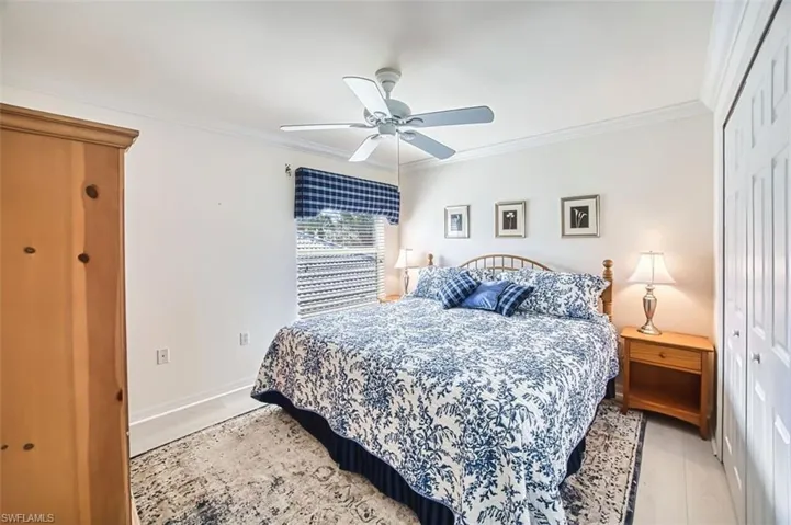 Bedroom featuring a closet, ornamental molding, and a ceiling fan