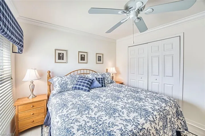 Bedroom with crown molding, a closet, and a ceiling fan