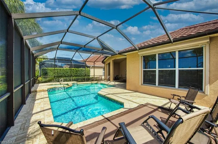 Relaxing pool / spa with a patio area, a sunroom, and a lanai