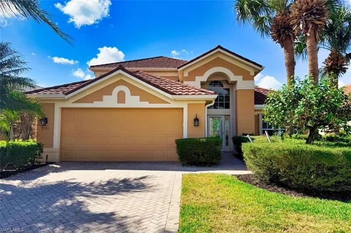 Mediterranean / spanish-style home featuring a garage, a tile roof, stucco siding, and decorative driveway
