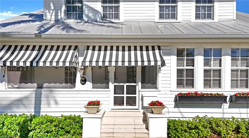 Property entrance featuring a metal roof