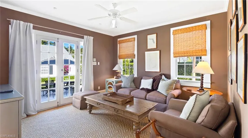 Living area featuring a ceiling fan, wood finished floors, french doors, and ornamental molding