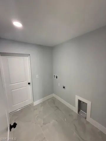 Laundry room with light marble finish flooring, hookup for a washing machine, electric dryer hookup, and recessed lighting