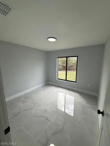 Empty room with baseboards and light marble finish flooring