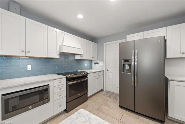 Kitchen with Hood, Stainless Steel Appliances, Motion Sensor Under Cabinet Lighting, and Counters that absolutely shine!