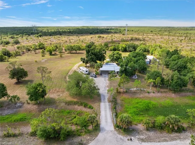 Almost 6 Acres of Absolute Bliss - Citrus trees, orchids, gardens, sun room, water feature, studio, pole barn, rv storage, and an absolutely breathtaking home.