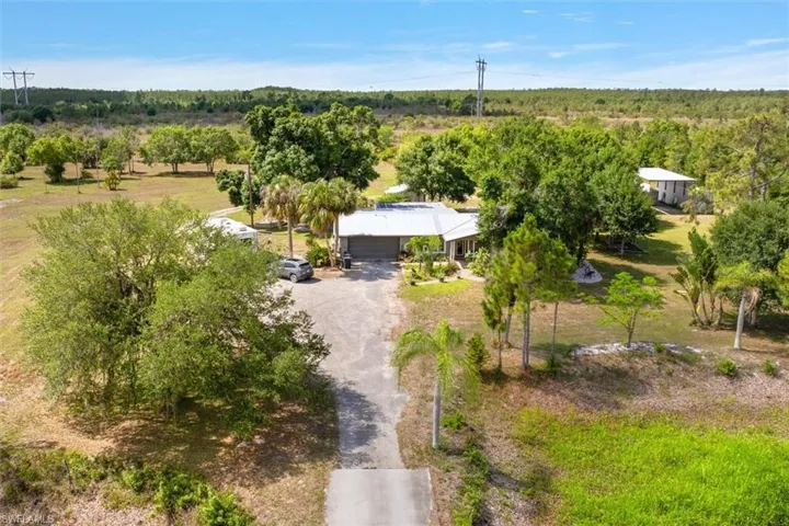 Almost 6 Acres of Absolute Bliss - Citrus trees, orchids, gardens, sun room, water feature, studio, pole barn, rv storage, and an absolutely breathtaking home.