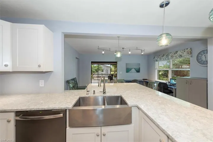 Kitchen Overlooking the Enclosed Patio and Breakfast Bar with a view of the Office Space