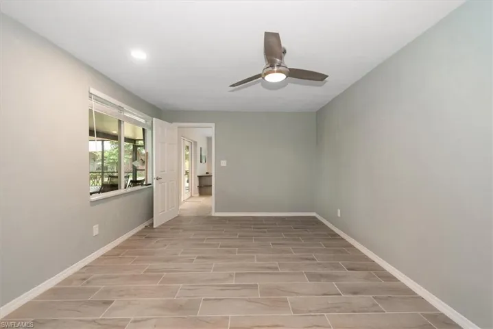2nd Master Bedroom with remote ceiling fan, wood tile finished floors, baseboards, and recessed lighting.