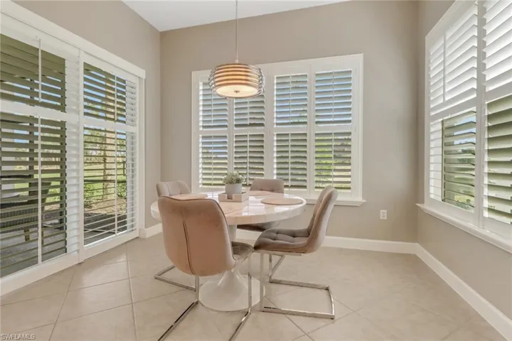 Dining area with tile patterned flooring, baseboards, and plenty of natural light