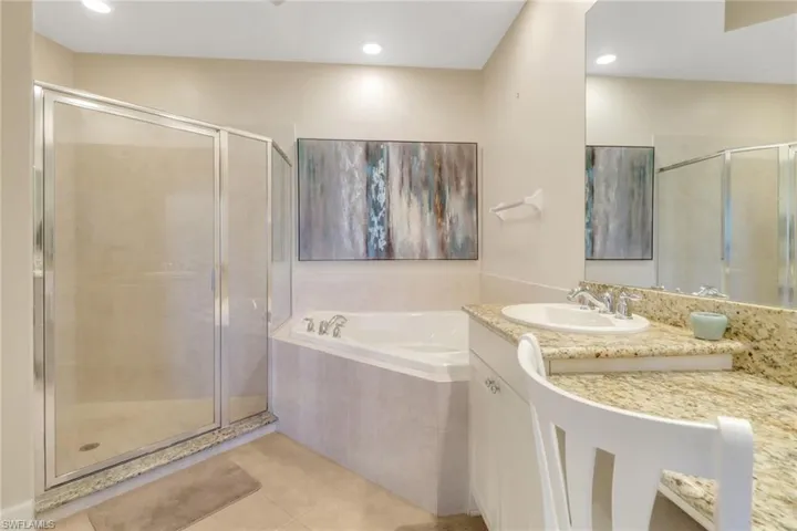 Bathroom featuring a bath, vanity, tile patterned flooring, and a stall shower