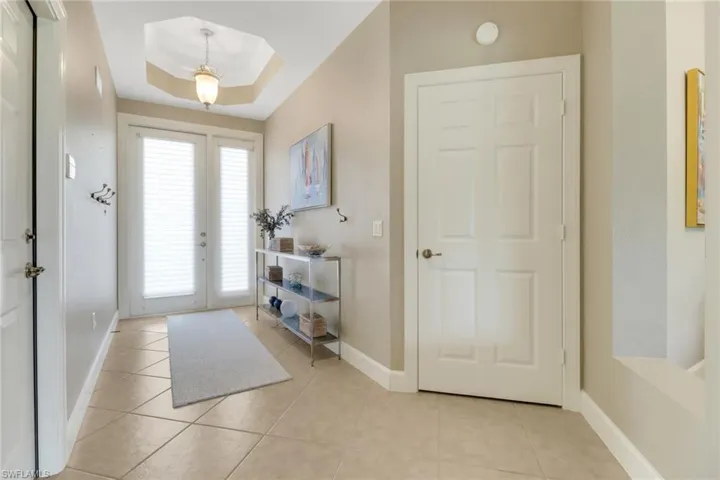 Foyer featuring baseboards and light tile patterned floors