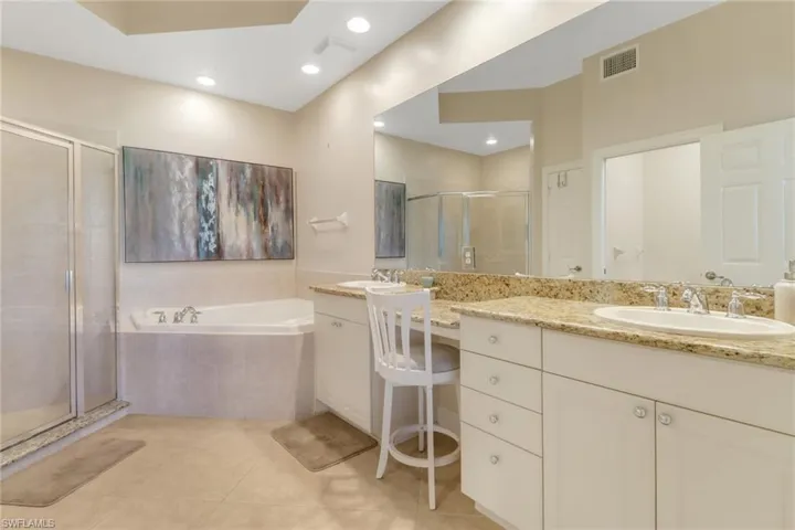 Full bath with vanity, visible vents, tile patterned floors, a stall shower, and a bath