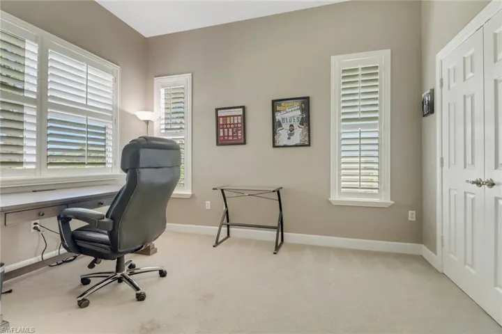 Home office with carpet flooring and baseboards