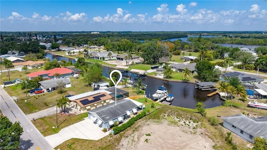 Birds eye view of property with a water view and a residential view
