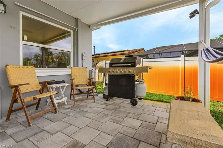 View of patio with a grill
