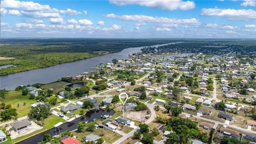 Birds eye view of property with a water view and a residential view
