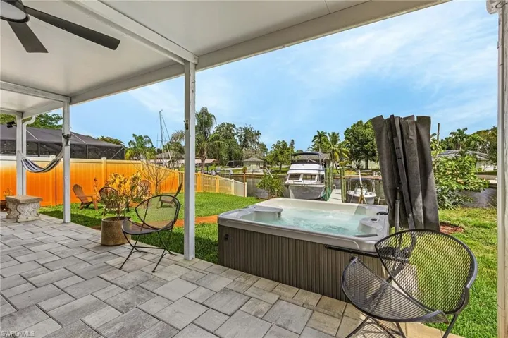 View of patio / terrace with a fenced backyard and a hot tub