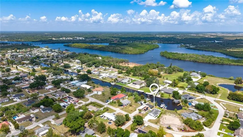 Birds eye view of property featuring a water view and a residential view