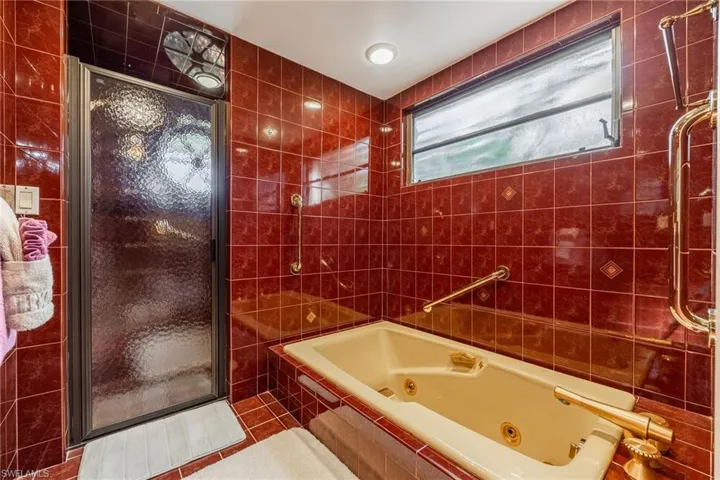 Bathroom featuring  walk in shower, tile patterned floors, and tile walls