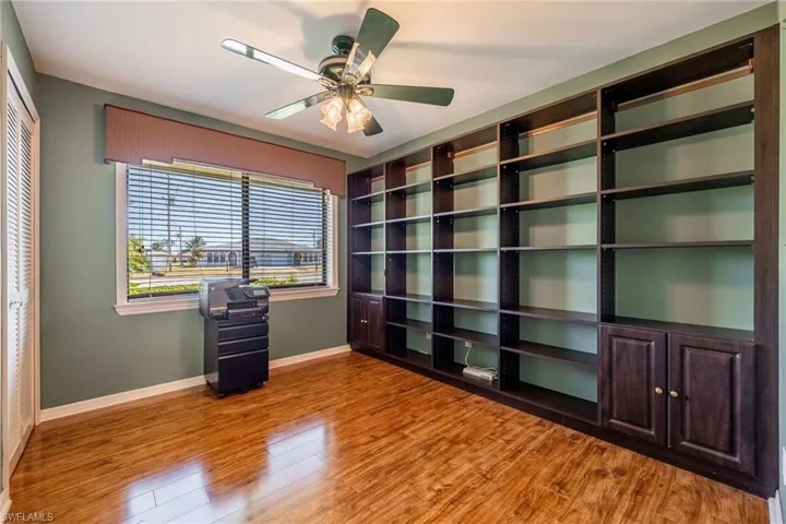 Guest Bedroom #1 used as an office with built-in bookshelves & walk-in closet.