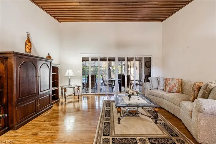Formal Living room with wooden ceiling with sliders leading out to the lanai