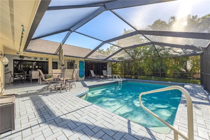 View of swimming pool featuring a lanai and a patio