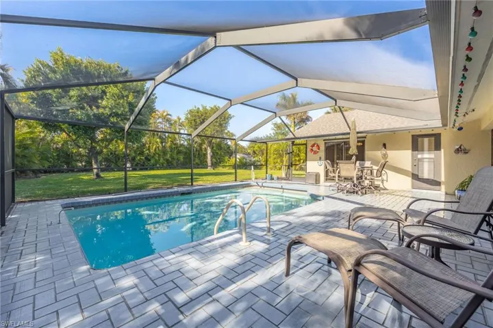 View of pool with a lanai, a yard, and a patio