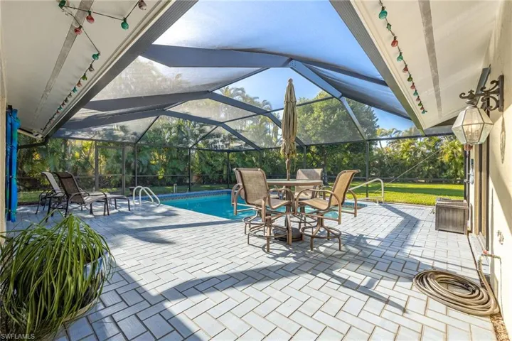 View of patio featuring glass enclosure