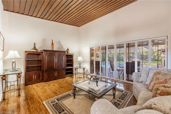 Living room featuring hardwood / wood-style floors, plenty of natural light, and wood ceiling