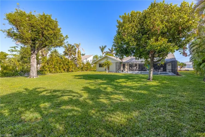 View of yard with a pool and a lanai