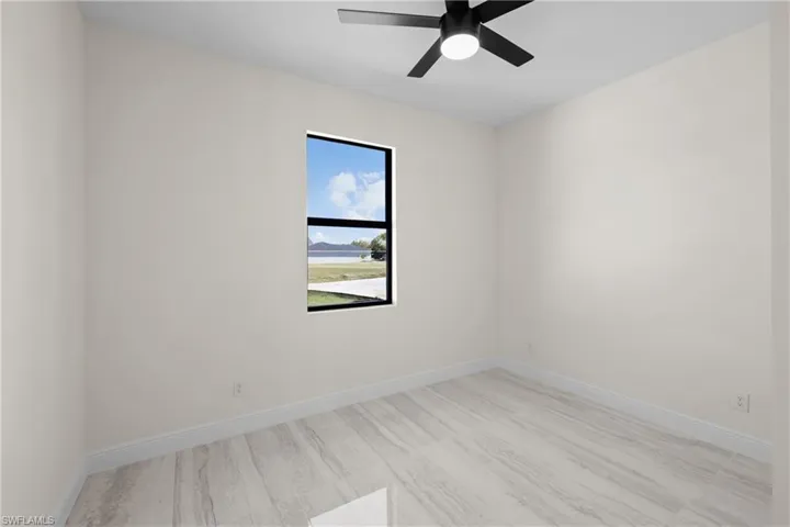 Empty room with baseboards and ceiling fan