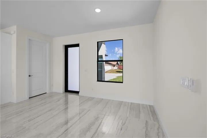 Empty room featuring recessed lighting and baseboards