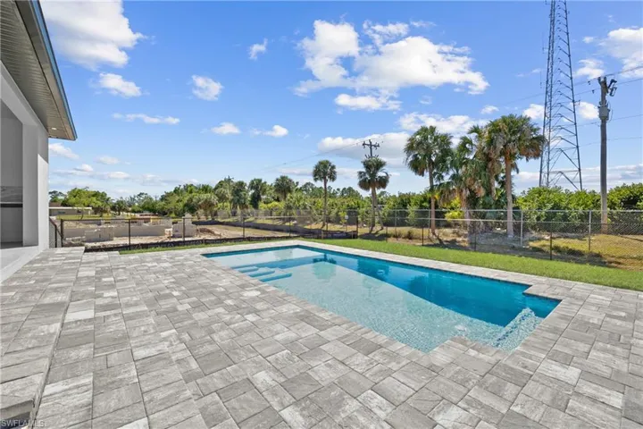 View of pool with a fenced in pool, a patio, and a fenced backyard